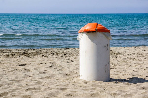 Trash can on the beach sunny day. Concept photo of a clean beach