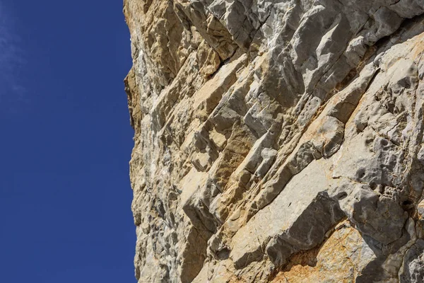 great rock wall, cliff against the blue sky