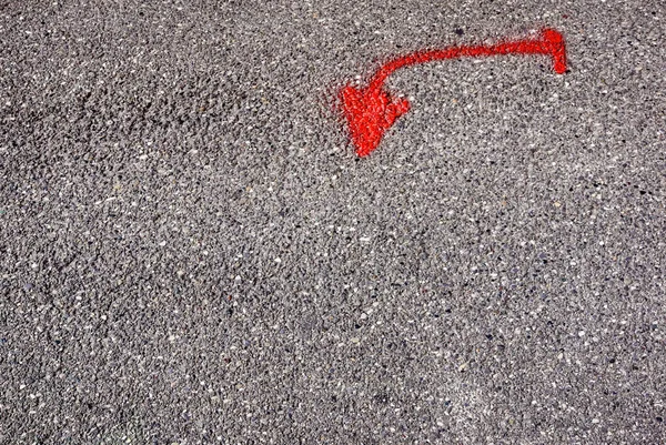 red arrow on road asphalt pointing up weathered .