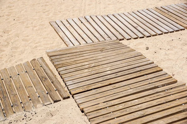 在金色沙滩上的木地板 — 图库照片