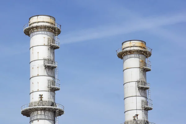 Pipes of industrial factory and blue sky background .