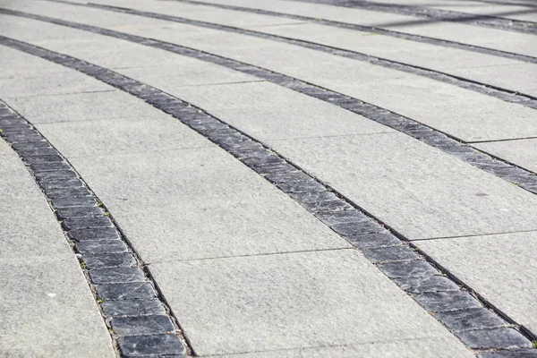 Stone trottoaren konsistens. Granit kullersten stenas trottoaren bakgrund. Abstrakt bakgrund av gamla kullerstensbelagda trottoaren — Stockfoto