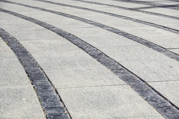 Stone trottoaren konsistens. Granit kullersten stenas trottoaren bakgrund. Abstrakt bakgrund av gamla kullerstensbelagda trottoaren — Stockfoto