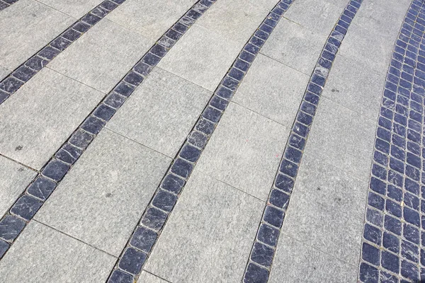 Stone trottoaren konsistens. Granit kullersten stenas trottoaren bakgrund. Abstrakt bakgrund av gamla kullerstensbelagda trottoaren — Stockfoto