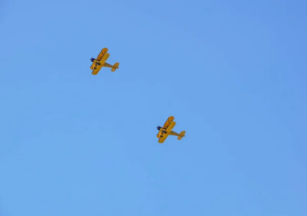 Two vintage airplane in flight . at empty blue sky — Stock Photo, Image