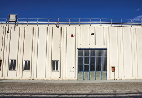 Cargo gate of Industrial warehouse. Industrial door. View on the one gates of big warehouse facade. Front view