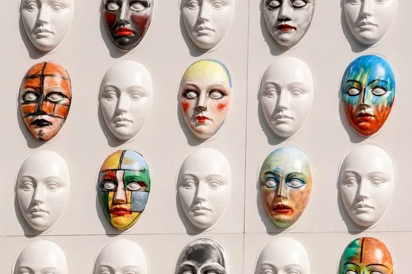 Carnival masks hanging on wall boards lie
