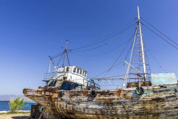 Old fishing ship waiting for repairs on the desert coast of the island of Cyprus.