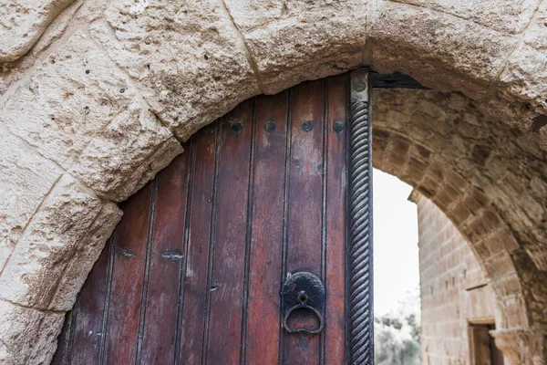 Stone arch of the entrance gate in the old Orthodox monastery on the island of Cyprus