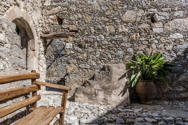 An old wooden bench in the small courtyard of the monastery Preveli