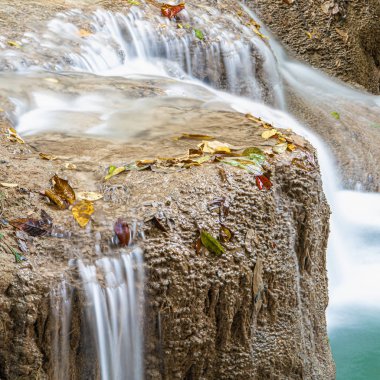 Cool streams of Erawan mountain waterfall in Kanchanaburi province in Western Thailand