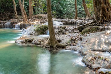 Cool streams of Erawan mountain waterfall in Kanchanaburi province in Western Thailand