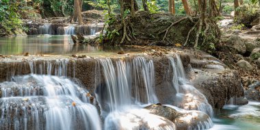 Cool streams of Erawan mountain waterfall in Kanchanaburi province in Western Thailand