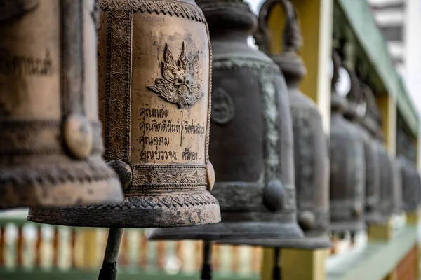 Endless row of bronze bells on the bell tower of the Thai Tiger temple in Kanchanaburi province