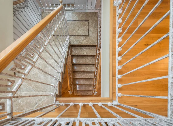 Marble stairs with wrought iron stair railingin in luxury villa