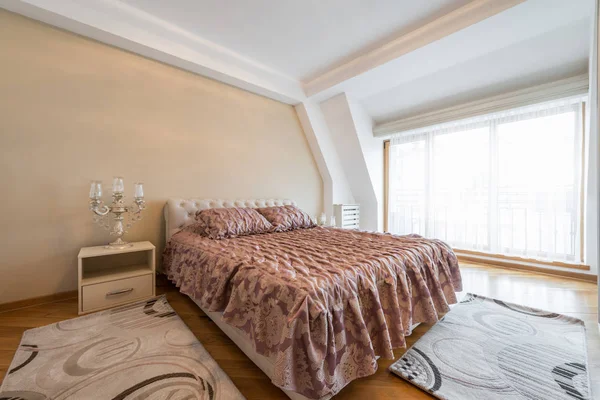 Interior of a luxury loft bedroom with master bed