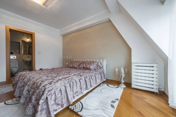 Interior of a luxury loft bedroom with master bed and bathroom