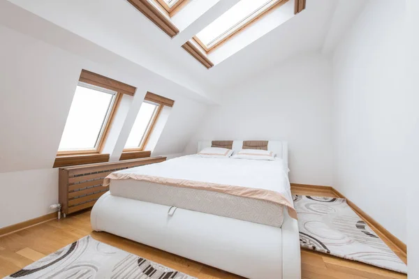 Bedroom interior in luxury loft, attic, apartment with roof wind — Stock Photo, Image