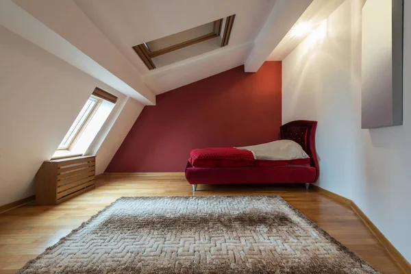 Bedroom interior in luxury red loft, attic, apartment with roof