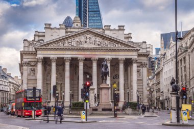 London, England - Iconic red double decker bus and the Royal Exchange building clipart
