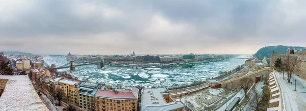 Budapest, Hungary - Panoramic skyline view of Budapest with the icy River Danube and Chain Bridge and other landmarks taken from the Buda Castle (Royal Palace) at winter time — Stock Photo, Image