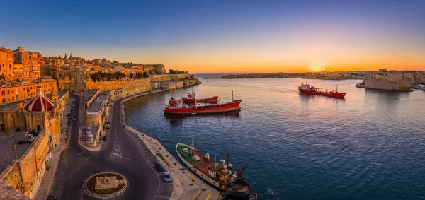Valletta, Málta - panorámás lövés egy csodálatos nyári napkelte Valletta Grand kikötő hajók és az ősi házak és a falak a máltai főváros. — Stock Fotó