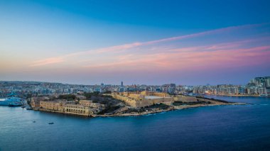 Valletta, Malta - Panoramic skyline view from the top of Valletta, the capital city of malta with Manoel Island and Sliema at sunset clipart