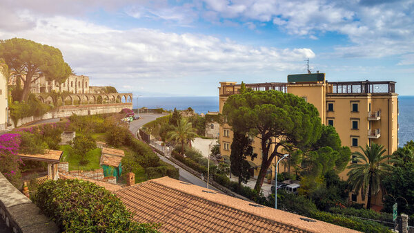 Taormina, Sicily - Beautiful view of the famous hilltop town of Taormina with palm tree, medanean sea and sunshine
