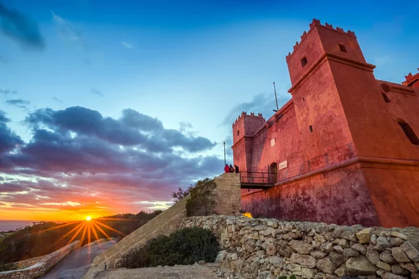 Il-Mellieha, Malta - Tourists watching sunset at St Agatha's Red Tower with beautiful sky and clouds — Stock Photo, Image