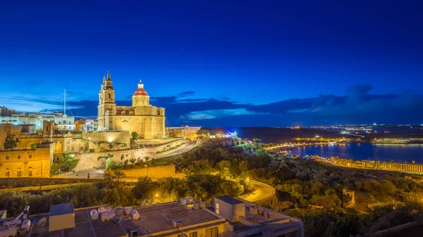 Il-Mellieha, Malta - Vista panorámica del horizonte de Mellieha con la hermosa iglesia parroquial de Mellieha y la bahía de Mellieha a la hora azul con la isla de Gozo al fondo — Foto de Stock