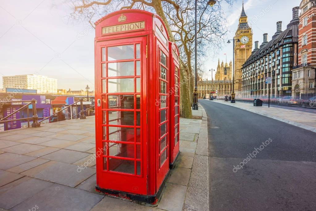 London, England - Traditional British red telephone box at Victoria Embankment with Big Ben at background