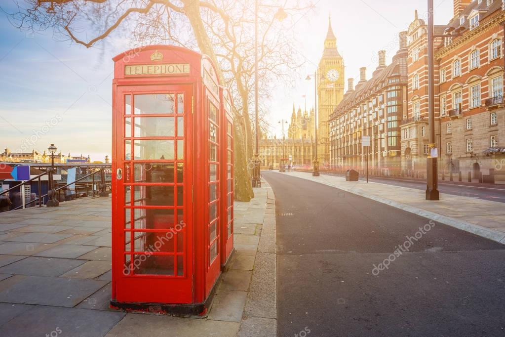 London, England - Traditional Old British red telephone box at Victoria Embankment with Big Ben at background 