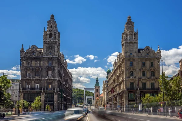 Budapest, ungarisch - das schöne klotild und matild palais am ferenciek platz, ein neobarockes doppelschloss mit elisabeth brücke und gellert hügel im hintergrund. Starker Verkehr in Budapester Innenstadt — Stockfoto