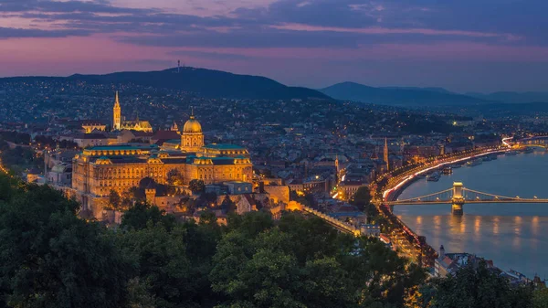 Budapest, Ungern - färgsprakande solnedgång på magiska timmen över Budapest med Buda Castle kungliga palatset och berömda Szechenyi Kedjebron — Stockfoto