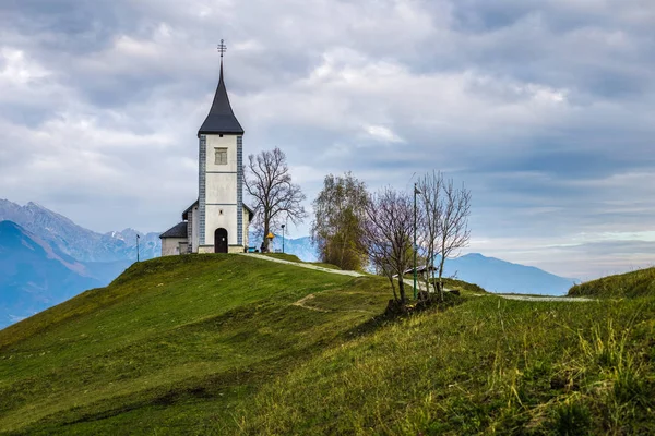 Jamnik, Slovenia - Красивая церковь Святого Примоза в Slovenia около Jamnik с Юлианскими Альпами на заднем плане — стоковое фото