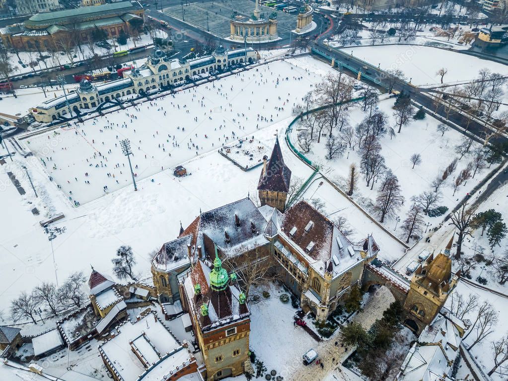 Budapest, Hungary - Aerial skyline view of snowy Vajdahunyad Castle with City Park Ice Rink and Heroes' Square at background on a winter morning