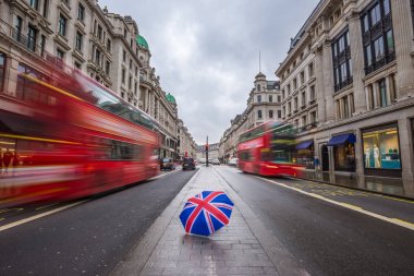 Londra, İngiltere - İngiliz şemsiye ile meşgul Regent Street'teki hamlesinde ikonik kırmızı Çift katlı otobüs