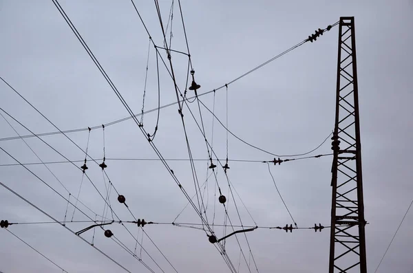 Railroad overhead lines against clear blue sky, Contact wire. High voltage railroad power lines on neutral blue sky background