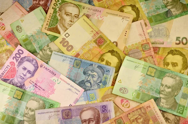 さまざまな色やサイズの多くのウクライナの紙幣の背景イメージです ウクライナの銀行の操作の概念イメージ撤退資金 富とウクライナのお金の巨大な合計の保有 — ストック写真