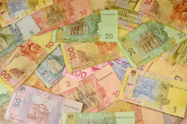 さまざまな色やサイズの多くのウクライナの紙幣の背景イメージです ウクライナの銀行の操作の概念イメージ撤退資金 富とウクライナのお金の巨大な合計の保有 — ストック写真