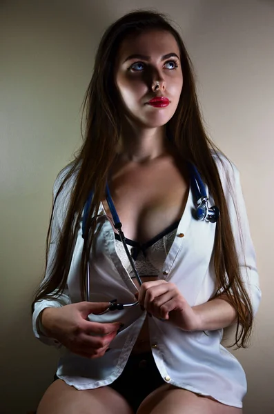 Jovem enfermeira sentada com estetoscópio — Fotografia de Stock