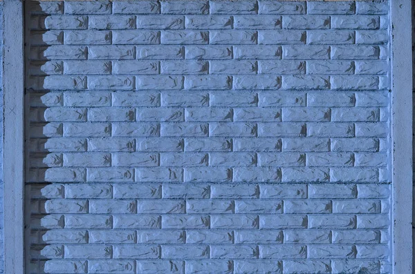 Stone fence texture - building feature. Texture of blue concrete fence with relief and texture like a stone wall