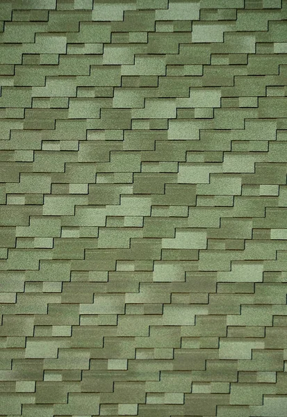 The texture of a thin coating of the roof with a rough colored surface, portions of which overlap each other