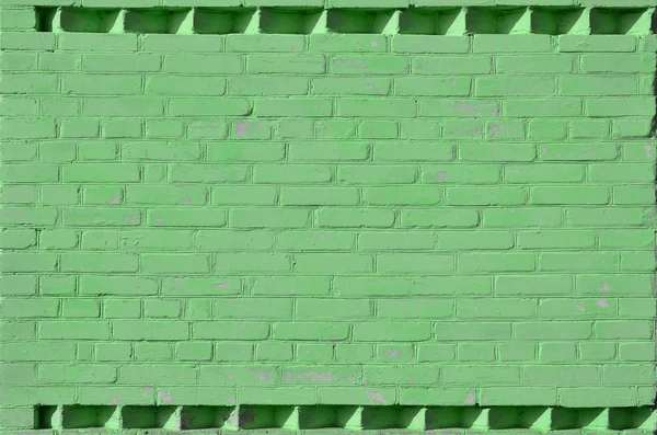 The texture of green wall from a variety of old and dirty brick. Detailed pattern of a plurality of different sizes of brick worn out