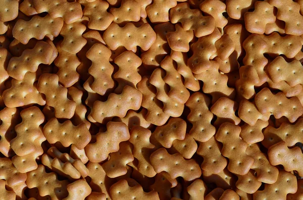 Pattern of a many yellow salted crackers — Stock Photo, Image