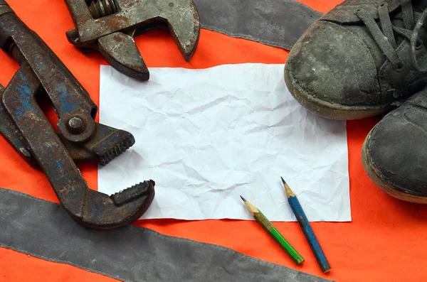 Adjustable wrenches with old boots and a sheet of paper with two — Stock Photo, Image