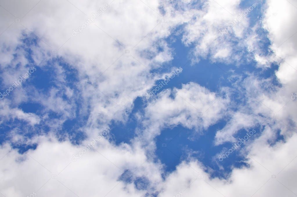 A photo of a bright and shiny blue sky with fluffy and dense whi
