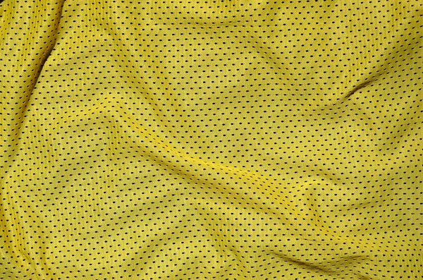 織り目加工の背景を作成する黄色ポリエステル ナイロン スポーツウェア パンツのクローズ アップ — ストック写真