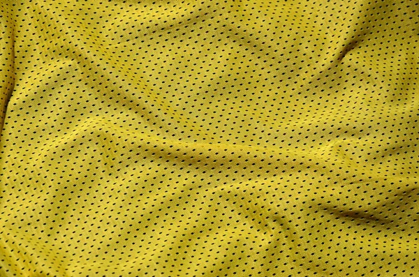 スポーツ服の生地テクスチャ背景 黄色い布織物表面の平面図 — ストック写真