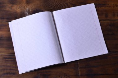 Bir temiz beyaz okul çek defteri kahverengi ahşap arka plan üzerinde fotoğraf. Fikir veya ileti kavramı. Metin için yeterince boş alana